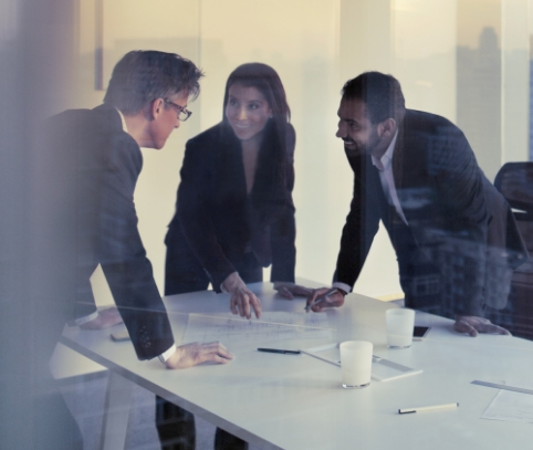 three business assocaites talking at a table