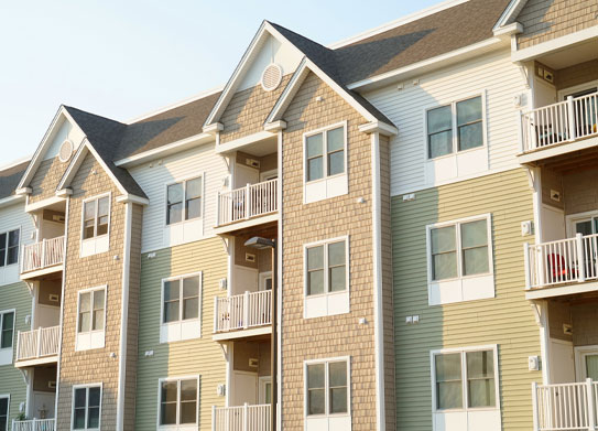 Exterior apartment building set over a pond