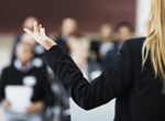 image of a person in focus in the foreground and people blurred in the background